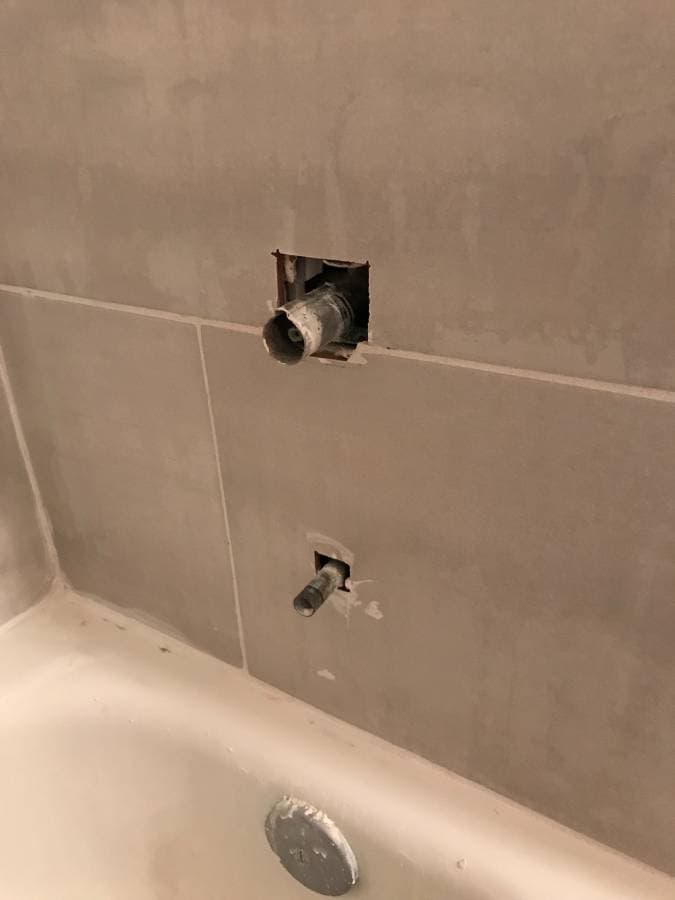 picture of a bathtub spout and hot and cold handle ready to be installed detailer
